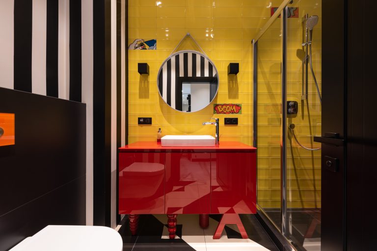 A Very Colorful Bathroom With Black, White, Red, And Yellow As Its Primary Colors.